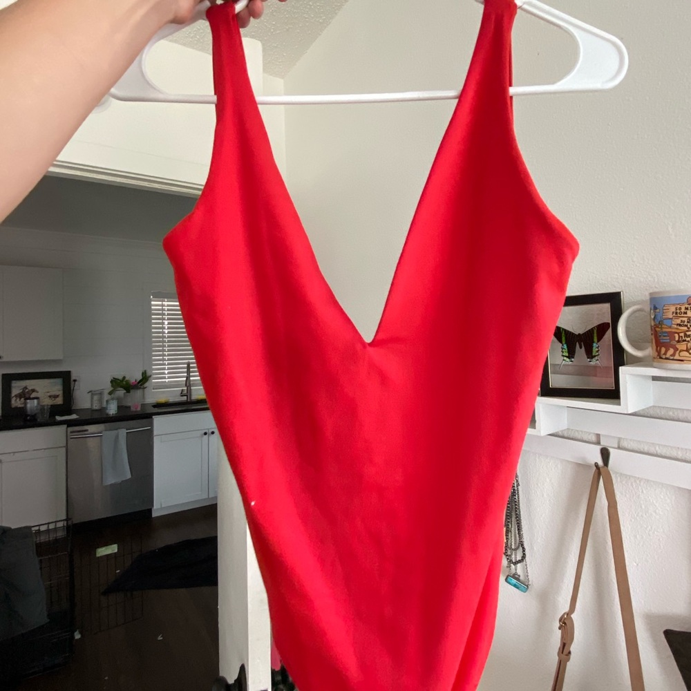 Red body suit with open back- NEVER WORN. BRAND NEW.